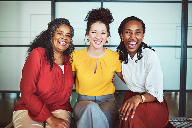 istock Three Happy Diverse Businesswomen Hugging and Smiling at Camera 2240930756