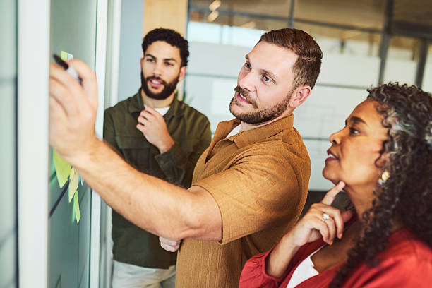 istock Diverse Team Planning Strategy with Sticky Notes on Glass Wall 2240930804
