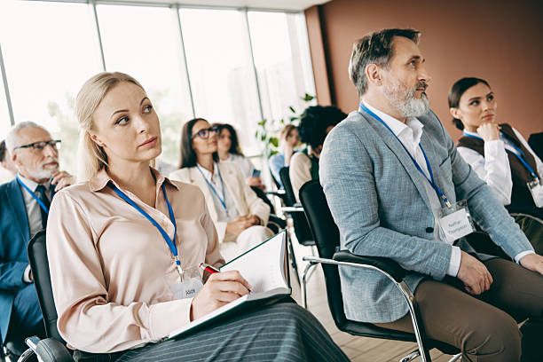 istock Group of professionals attentively participating in a corporate training session in a modern office setting for learning 2240932265