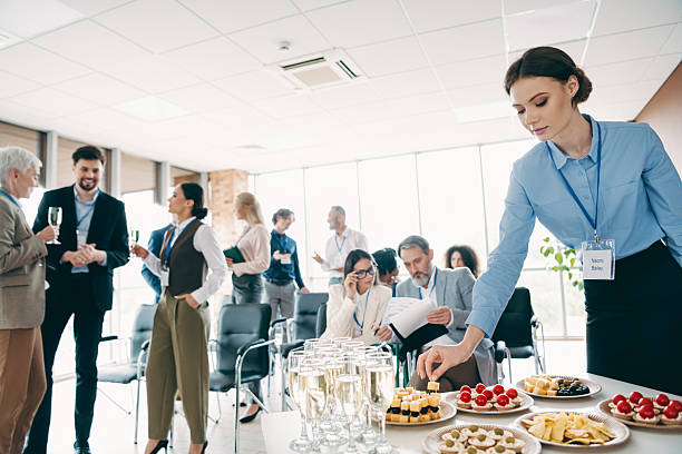 istock Professional team gathers for a meeting with discussions, snacks, and networking in a corporate workspace to foster collaboration 2240932309