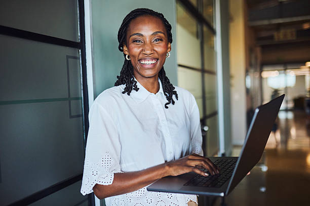 istock Joyful Black Businesswoman Smiling While Working on Laptop 2240932775