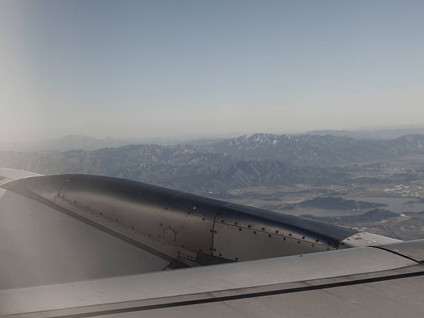 istock Overlooking the mountains through the airplane window 2240933435
