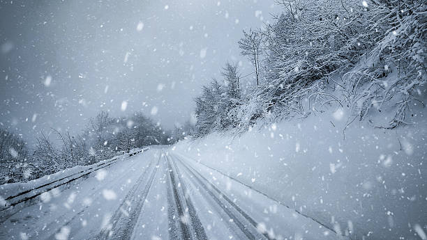 Snowstorm on a Mountain Road in Winter Forest