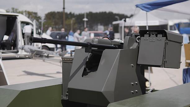 istock Military Exhibit Showcases Advanced Weapon Systems at a Defense Technology Fair Held in a Spacious Outdoor Venue During Daylight Hours 2240939119