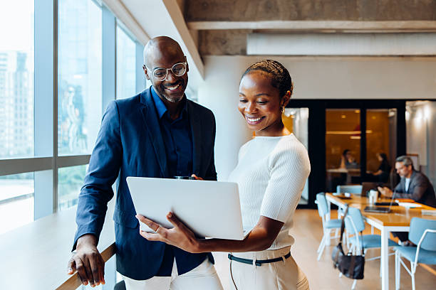 istock Professionals discussing ideas with a laptop in a bright office space 2240940577