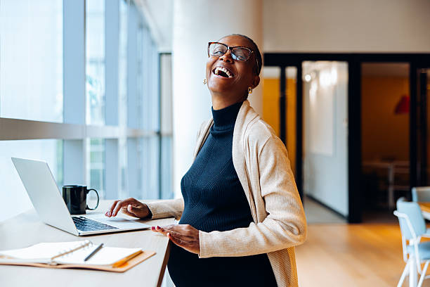 istock Smiling pregnant woman working on a laptop in a bright office setting 2240940716