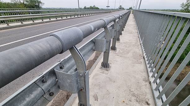 istock Pedestrian walkway on bridge with metal guardrail and road protection system 2240941104