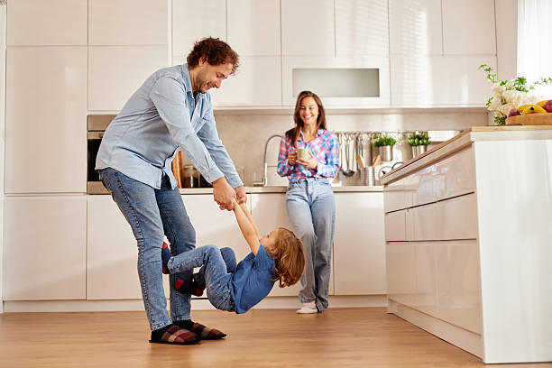 istock Happy family playing together in modern kitchen 2240941279