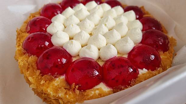 Delicious berry cake with whipped cream and crunchy crust close-up