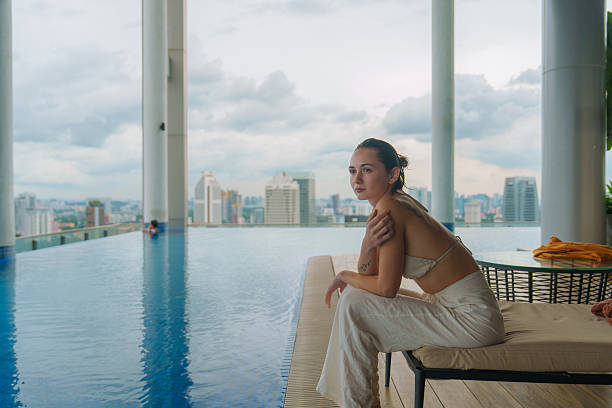 istock Woman relaxing at rooftop swimming pool 2240941362
