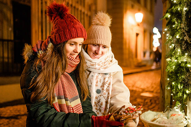 istock Two women looking Christmas gift in Prague, Czech Republic 2240943346