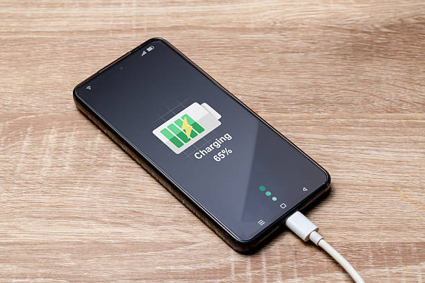 istock A smartphone being charged on the wooden table 2240943434