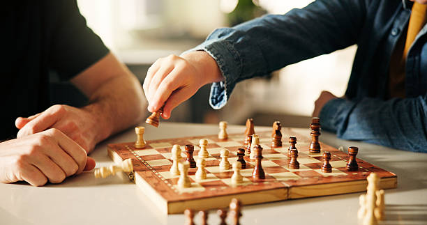istock Playing, hands and father with kid for chess in home for learning, development or bonding. Teaching, competition and dad with boy child for board game with checkmate for problem solving skills. 2240947425