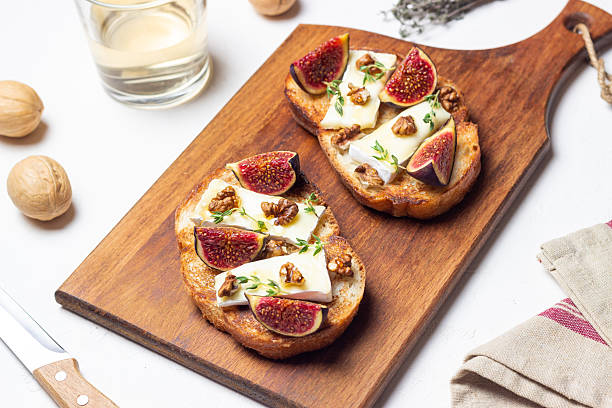 istock Bruschetta with brie cheese, figs, nuts, and honey. Vegetarian food. Appetizer. 2240955231
