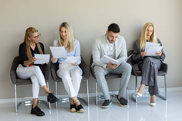 istock A group of professionals waits attentively in a modern office reception area 2240955656