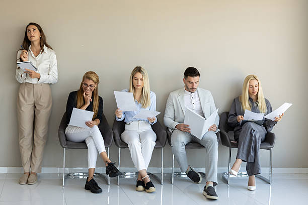 istock A group of professionals waits attentively in a modern office reception area 2240955710