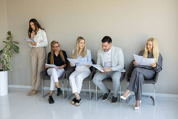 istock A group of professionals waits attentively in a modern office reception area 2240955711
