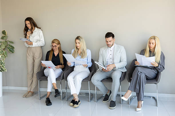 istock A group of professionals waits attentively in a modern office reception area 2240955716