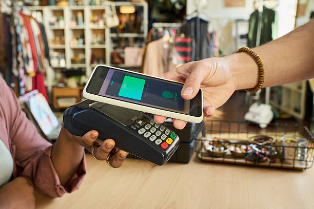 istock Caucasian Young Adult Man Making Contactless Payment Using Smartphone 2240956366
