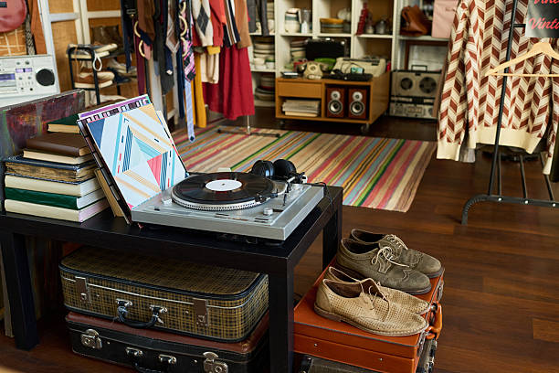 istock Vintage Turntable Playing Vinyl Record in Retro Thrift Shop Interior Setting 2240956384