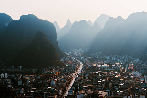 Scenic high angle view from mountain at town in Yangshuo, Guilin, China at sunset