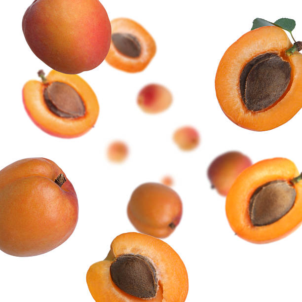 istock Fresh apricots swirling in air against white background 2240958156