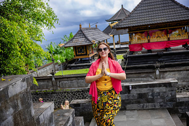 Young woman tourist in Traditional balinese hindu Temple Taman Ayun in Mengwi. Bali, Indonesia.