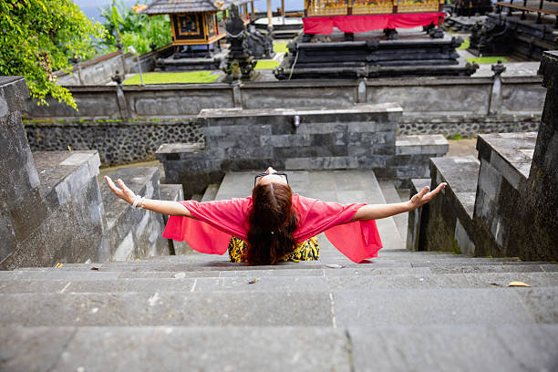 Young woman tourist in Traditional balinese hindu Temple Taman Ayun in Mengwi. Bali, Indonesia.