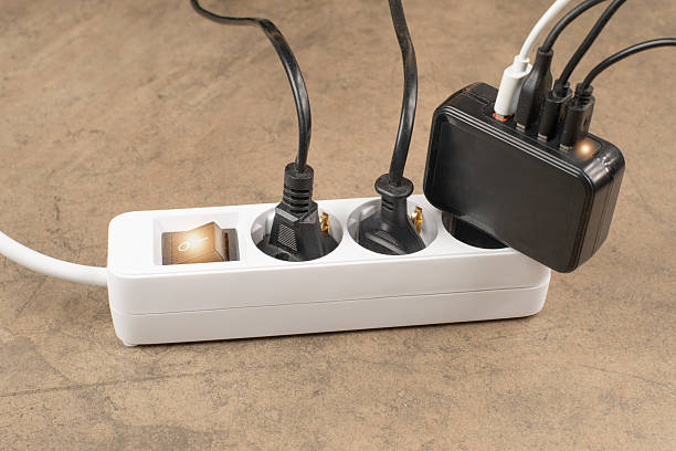 istock Extension power outlet socket overloaded with plugs, USB adapter with charge cables plugged into power strip 2240963269