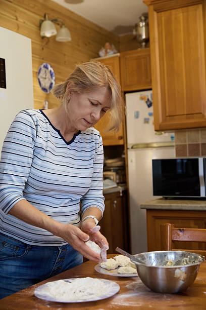 istock Cheesecakes Preparation: Woman Baking in Cozy Kitchen 2240964697