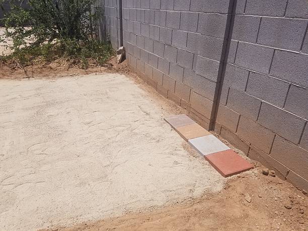 istock Four Different Colored Pavers Lined Up on Ground, Choosing Colors for Patio 2240966169