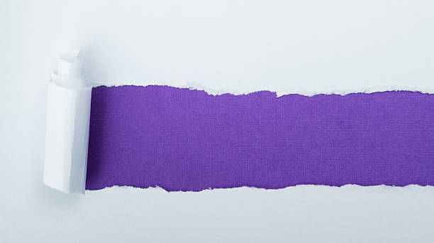 istock Torn white paper revealing purple background 2240966401