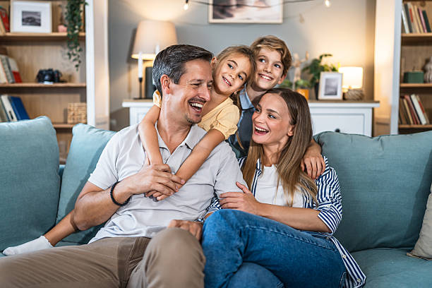 istock Happy family relaxing at home on couch 2240975246