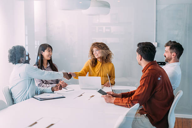 istock Businesspeople shaking hands across the table. 2240975318