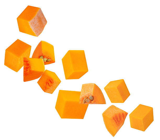 istock Flying Pumpkin cubes isolated on white background. Pumpkin Explosion. Levitating  Pumpkin pieces with seeds. Top view. Flat lay  2240980995