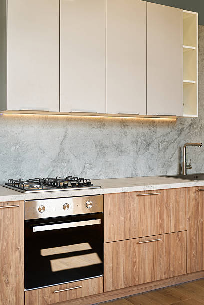 istock Modern kitchen featuring a sleek black gas oven and wooden cabinets 2240981002