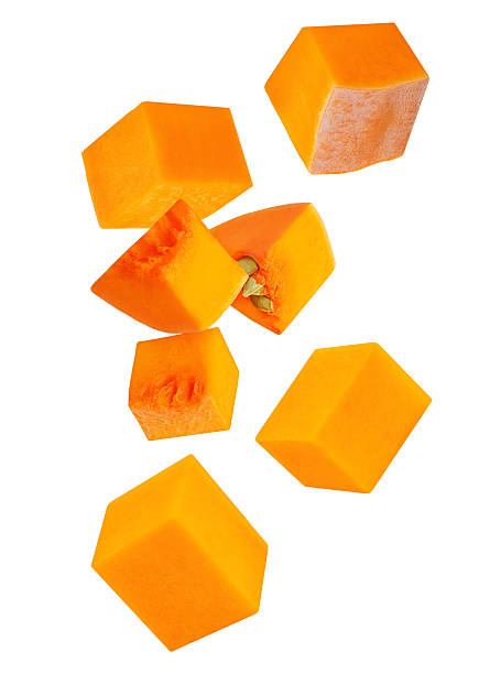 istock Flying Pumpkin cubes isolated on white background. Pumpkin Explosion. Levitating  Pumpkin pieces with seeds. Pattern 2240981094
