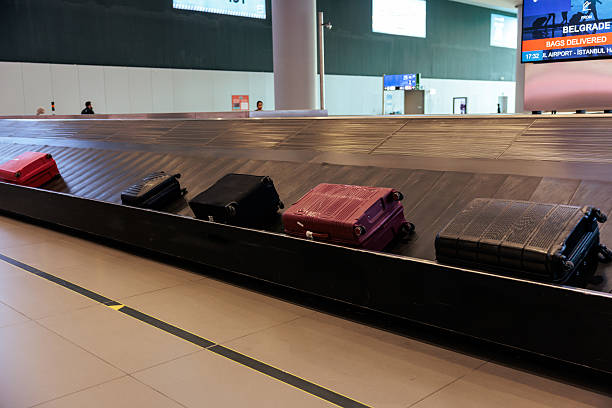istock Luggage On Airport Conveyor Belt 2240981114