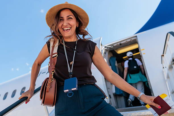 istock Happy Woman Boarding an Airplane for Her Flight 2240981169