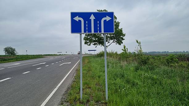 istock Directional road sign showing multiple lane turns and arrows 2240981636