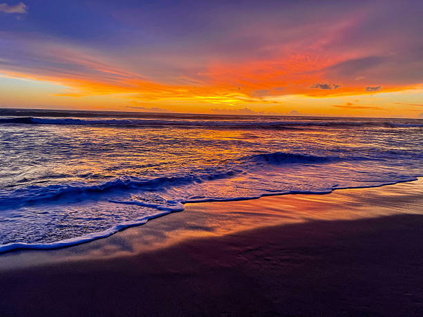 istock Purple-Orange Waves Rolling on the Shore 2240987576