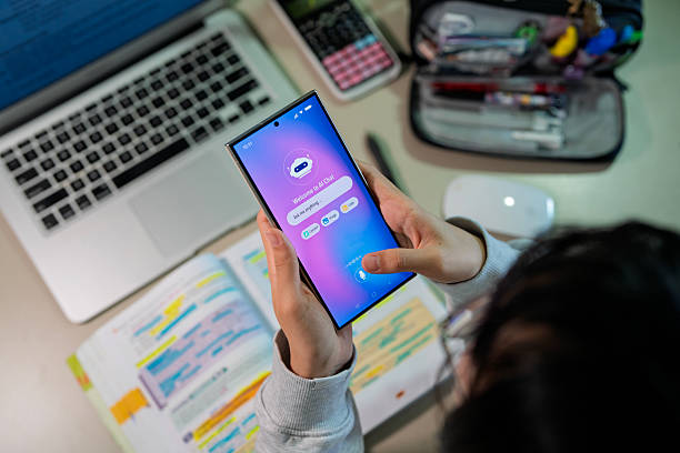 istock Teenage girl using AI chatbot on smartphone while studying at desk 2240988267