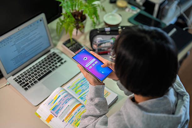 istock Teenage girl using AI chatbot on smartphone while studying at desk 2240988680