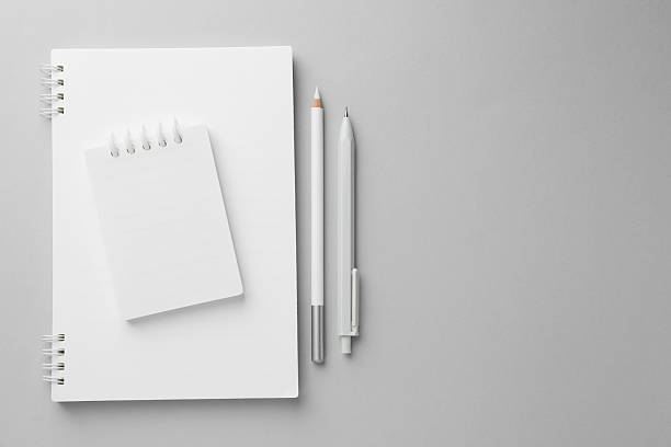 istock White notebooks, pen and pencil on light grey background, top view. Space for text 2240988864