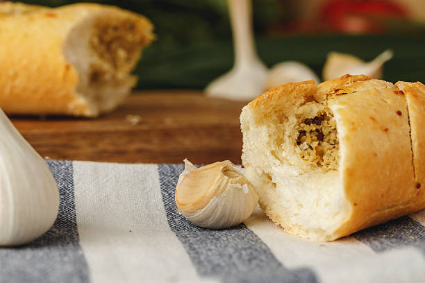 istock Sliced fresh baguette with garlic oil and herbs 2240989409