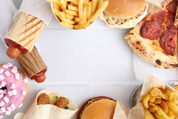 istock Different delicious fast food on white tiled table, flat lay. Space for text 2240990388