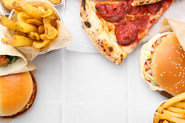 istock Different delicious fast food on white tiled table, flat lay. Space for text 2240990466