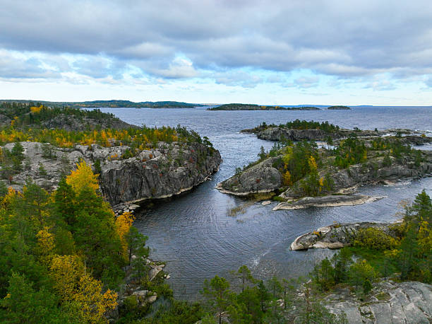 istock Rocky inlet and open water framed by autumn forest 2240990713