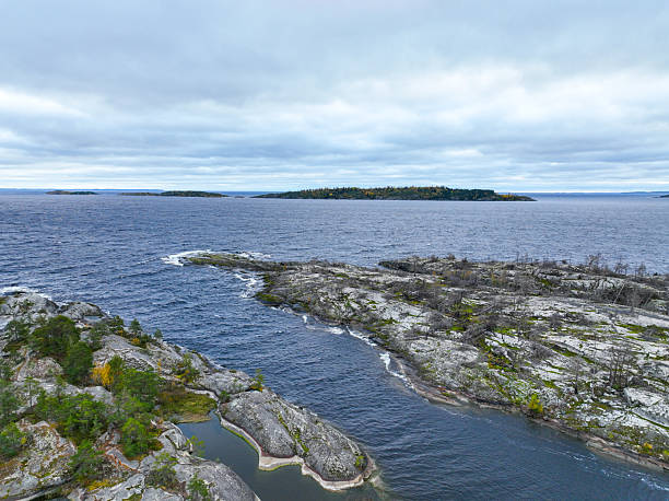 istock River channel opening into a massive, island-dotted lake 2240991388
