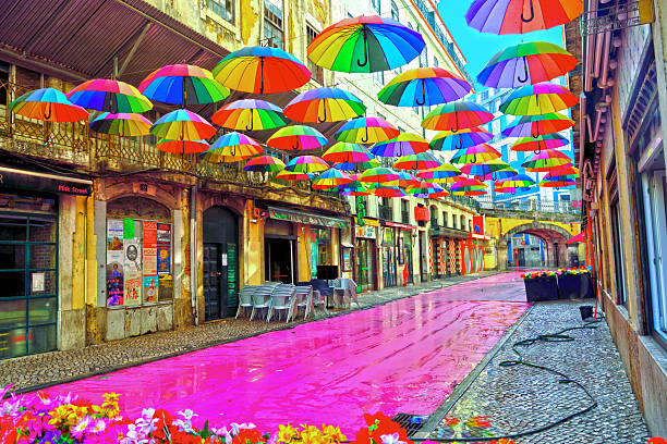 Pink Street (Rua Nova do Carvalho) This street is famous for its pink-painted pavement and the colorful umbrellas suspended above the heads of passer 30 May 2025 Lisbon Portugal